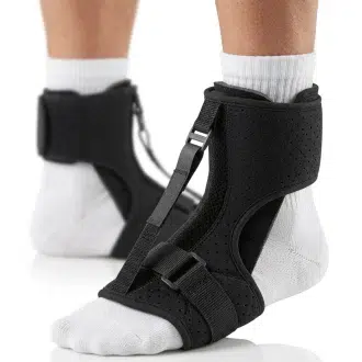 A night splint brace designed for Plantar fasciitis relief is shown on a man's foot against a clean white background. The device holds the foot in a gentle dorsiflexion position, maintaining a stretch along the Achilles tendon and plantar fascia. An adjustable tension strap secures the midfoot, allowing customizable support while padded contours ensure comfort. The rigid frame stabilizes the ankle, promoting proper alignment overnight to reduce morning stiffness. Soft, breathable materials line the interior for extended wear.